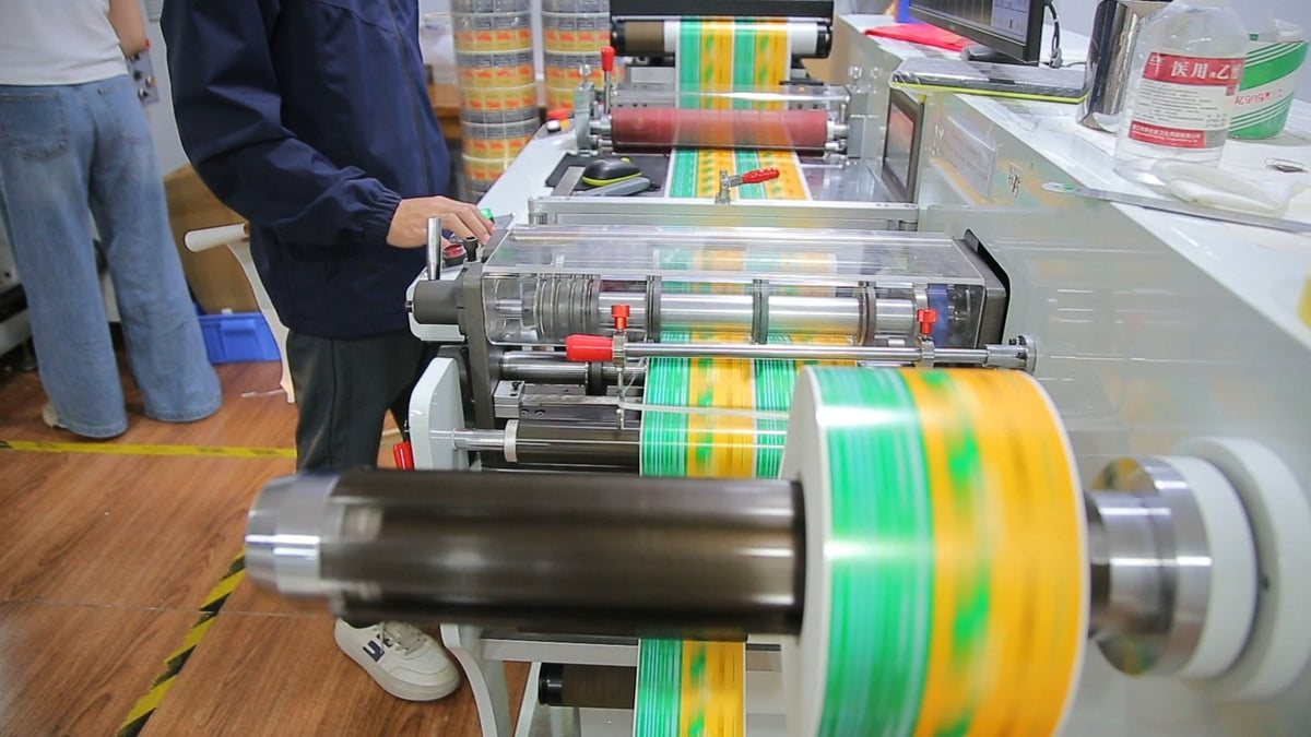 Printed roll material moving through production equipment